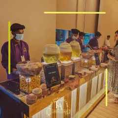 For an intimate corporate event, we created this clean and elegant Gol Gappa station. The setup features illuminated dispensers for our flavored waters and professional staff ready to serve, ensuring a seamless and high-end street food experience for all guests.