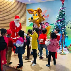 Children gather around Santa for a story and festive fun. Our Christmas celebrations are filled with magical moments.
