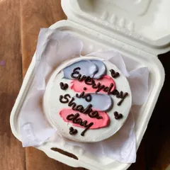 A motivational and fun bento cake with the message "Everyday is Shaka day." The colorful pink and purple brushstrokes add a splash of energy to the design.