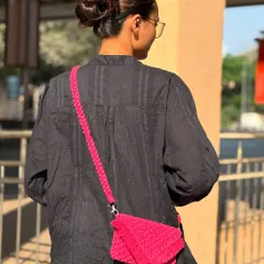A look at how the macrame sling bag sits when worn. The strap is designed for comfort, and the bag is just the right size for your phone, keys, and cards.