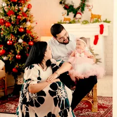 A heartwarming family portrait from a Christmas-themed shoot. The love and joy of the season are perfectly captured in their happy expressions.