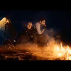 A moody campfire scene from the Freefire ad. The styling involved rugged, dark-toned outfits with modern accessories like fingerless gloves to create a contemporary action look.