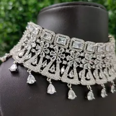 A close-up of the necklace, highlighting the pattern of square and teardrop-shaped stones that give it so much brilliance.