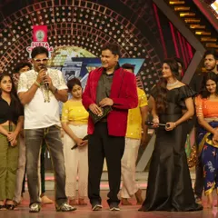Sharing the stage with fellow judges and hosts during a live taping. Working on a dance reality show requires quick thinking and the ability to articulate expert opinions clearly.