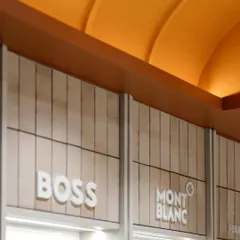 A detailed shot of the terracotta vaulted ceiling, where soft up-lighting highlights its ribbed texture, creating a significant architectural statement that defines the store's character.