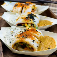 A fusion of two cultures, my Sushi Idli is a creative appetizer that always intrigues guests. Soft idli is rolled with crisp vegetables and served with coconut and tomato chutney, mimicking the look of a sushi roll.
