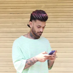 We can get creative with it. For my homeboy here, we did a modern mullet with a pop of pink and purple on top. This shows how you can combine a sharp haircut with a bold fashion color for a unique style.