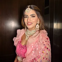 Carnival and Mehendi ready. This look is all about fun, with a bright pink outfit, glowing skin, and a playful, modern makeup style.