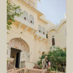 A sun-kissed daytime shot of the couple standing on a balcony of a beautiful heritage property. I use natural light to highlight the intricate architecture and the couple's connection.