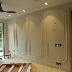 The process of bringing the vision to life, with the wall moldings being installed in the Harmony House family lounge.