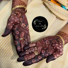 The rich, dark stain of a floral mehndi design, beautifully complemented by the client's rings. This is the result of pure, organic henna.
