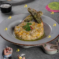 This delicious baked mac and cheese is from our kids' menu, but I've seen plenty of adults sneak a bite! It's cheesy, comforting, and served with fun Asterix and Obelix figures.