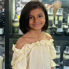 This young client is glowing with her new short bob. The cut is clean and chic, perfectly framing her smiling face.