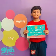 Look at that proud smile. This grade schooler has successfully performed his first dive forward roll. Acknowledging these moments helps build a child's confidence and motivation.
