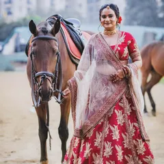 This full-length portrait showcases the bride's traditional attire alongside the noble presence of our horse. We help coordinate these shots to ensure both beauty and safety.