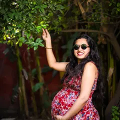 Maternity photos can be fun and playful too. We encouraged a spontaneous moment in the garden, with the mother-to-be interacting with her surroundings. This shot shows a different side of pregnancy, full of life and vibrant energy.