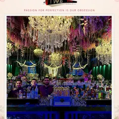 An opulent bar design for a welcome soirée at JW Marriott Bangalore, featuring dramatic crystal chandeliers and floral arrangements that create a magical, immersive experience for guests.