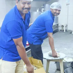 A behind-the-scenes look at our team working in the kitchen, preparing food with smiles on their faces.