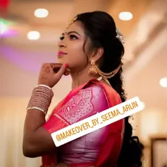 This side profile highlights the elegant hairstyle and jewellery for an engagement. The hair is styled in a modern, voluminous braid with delicate accessories, complementing the traditional jhumka earrings.