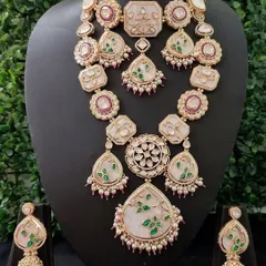 A unique and artistic rental set featuring white and green enamel work on a gold-tone base. This full bridal set has a modern yet royal feel, perfect for the bride looking for something different.