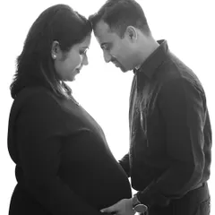 An intimate black and white portrait of a couple, forehead to forehead. Removing color allows the focus to be entirely on the emotion and connection.