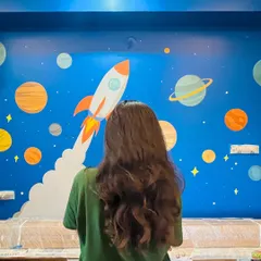 A final look at the completed solar system mural before the room is fully furnished. The vibrant colors and fun design make this a perfect feature wall for a kid's bedroom.