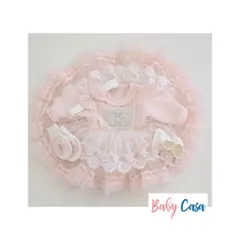 A flat lay of our delicate pink lace dress set. This shows the complete look, including the dress, matching headband, and booties, all crafted with the finest materials.