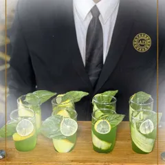 A server presents a tray of our refreshing mocktails, garnished with fresh basil and lime. Our drinks are crafted to bring balance, flavour, and finesse to every sip.