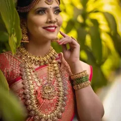 The classic Kasu Malai or coin necklace is a staple of South Indian bridal wear. This image showcases our intricately designed kasu haram paired with a matching choker and jhumkas.