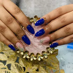 A striking combination of bold royal blue and a sheer nude accent nail with a cascade of silver rhinestones.