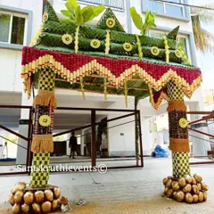 Another angle of our grand Chappra, showcasing the detailed craftsmanship. The pillars are wrapped in checkered leaf patterns and the base is decorated with coconuts, symbolizing prosperity.