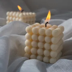 A close-up of my classic bubble candle, with its flame casting a warm and cozy light. It's the perfect accessory for a quiet evening.