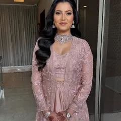 A classic half-pinup style with voluminous waves cascading down one shoulder. This is a timeless party hairstyle that suits many face shapes and outfits.