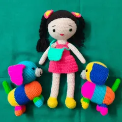 A cute doll with her two colorful puppy friends. These patchwork-style dogs are so bright and cheerful.