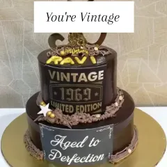 A "Vintage 1969, Aged to Perfection" two-tiered chocolate cake. This is a classic and popular theme for milestone birthdays, celebrating a life well-lived.