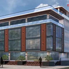 A 3D render for a proposed commercial building on Sarjapur Road, featuring a wide glass facade and a prominent terrace space on the upper floor.