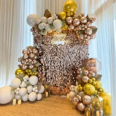 Another angle of the rose gold shimmer wall, showing how the balloon arrangement frames the backdrop to create a luxurious and inviting party atmosphere.