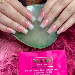 A beautiful example of our chrome-dusted baby boomer extensions. The seamless blend from a soft pink base to a crisp white tip gives a modern and sophisticated look to these square-shaped nails.