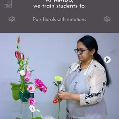A student carefully selects a stem, learning to pair florals with emotions. This is a core part of my teaching, moving beyond simple aesthetics to create powerful, meaningful designs.