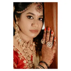 A captivating close-up of the bride, focusing on her striking eyes, intricate henna, and beautiful rings. This shot is all about the stunning details of the bridal look.