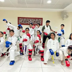 Ready for the challenge. A group of our students geared up in full WKF-approved protective equipment for a kumite (sparring) practice session, ready to train with intensity.