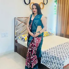 This is a lightweight printed saree perfect for parties or festive gatherings. The teal base is accented with a bold red and white marble-effect print on the pallu, creating a modern and artistic statement.