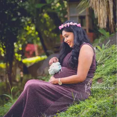 A sweet, joyful photo celebrating the anticipation of a new arrival. The soft makeup and floral crown add to the gentle and loving atmosphere of the shoot.