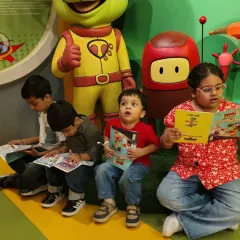 Our space isn't just for play. Here, a group of children enjoys a quiet moment reading books from our collection near the cafe.