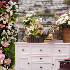 An enchanting blend of vintage and modern decor for a welcome brunch. We used a classic white dresser as a base for lush floral arrangements, creating a beautiful and unique focal point.