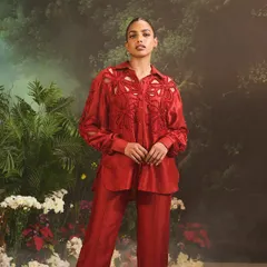 The Lunara Co-ord Set in a bold red. This stunning set showcases an embellished shirt with floral cut-out designs, paired with straight pants for a glamorous impression.