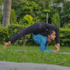This pose is a perfect blend of strength, flexibility, balance, and endurance. Here, a young student shows a deep standing split with a backbend.