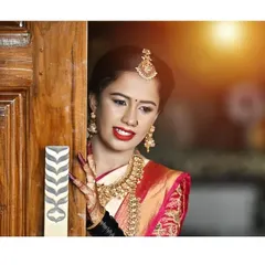 A moment of quiet beauty. This bride looks stunning with her classic red lip, gold jewellery, and a simple nose ring that adds a touch of tradition to her Muhurtham look.