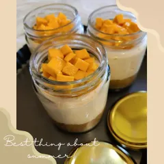 Our seasonal summer special, Mango Cheesecake served in individual jars. It features a biscuit base, creamy cheesecake filling, and is topped with fresh mango chunks.