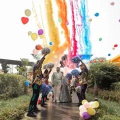 A grand welcome for the couple at their carnival-themed event. Dancers with pom-poms and colorful smoke bombs created a pathway of pure energy and excitement for their entrance.